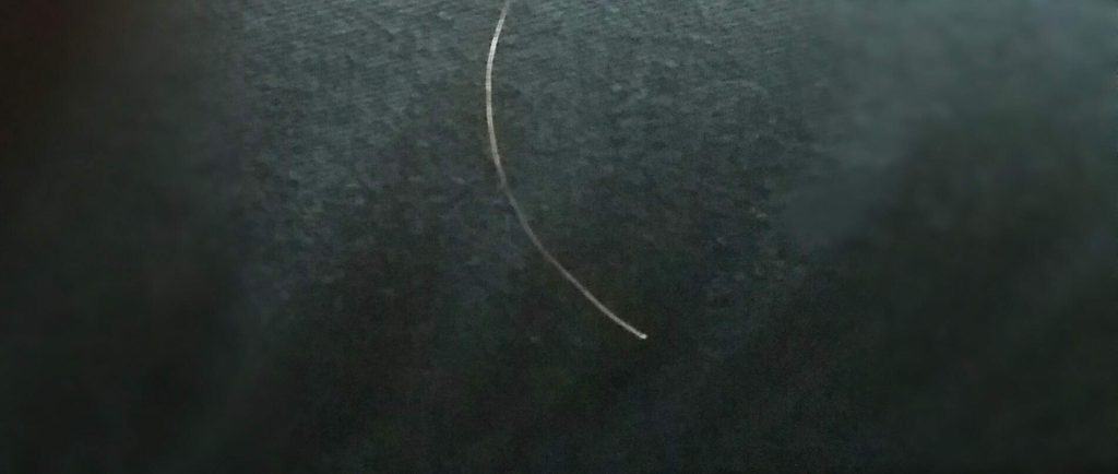 Image of  a single hair with a white tip: This is an example of hair breakage, and not real baby hair